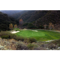 Glen Ivy Golf Club's 17th green is protected by two sand bunkers and bordered from all sides with the national forest.
