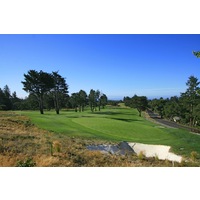 The par-5 ninth hole at Pasatiempo Golf Club has an elevated green near the clubhouse.