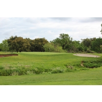 A hidden creek fronts the fifth green of the MacKenzie Course at the Haggin Oaks Golf Complex.