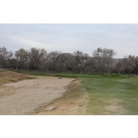 The 11th hole at Carlton Oaks Golf Club wraps around a pond.